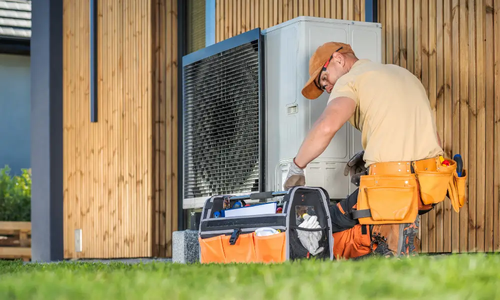 Heat pump engineer performing maintenance of an outside unit.