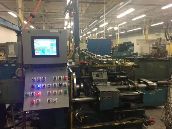 Machinery used in the friction welding process inside an industrial facility.