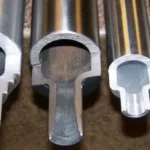 Cross-sectional view of cylindrical roll-formed metal components in various sizes, demonstrating the cylindrical roll forming process.